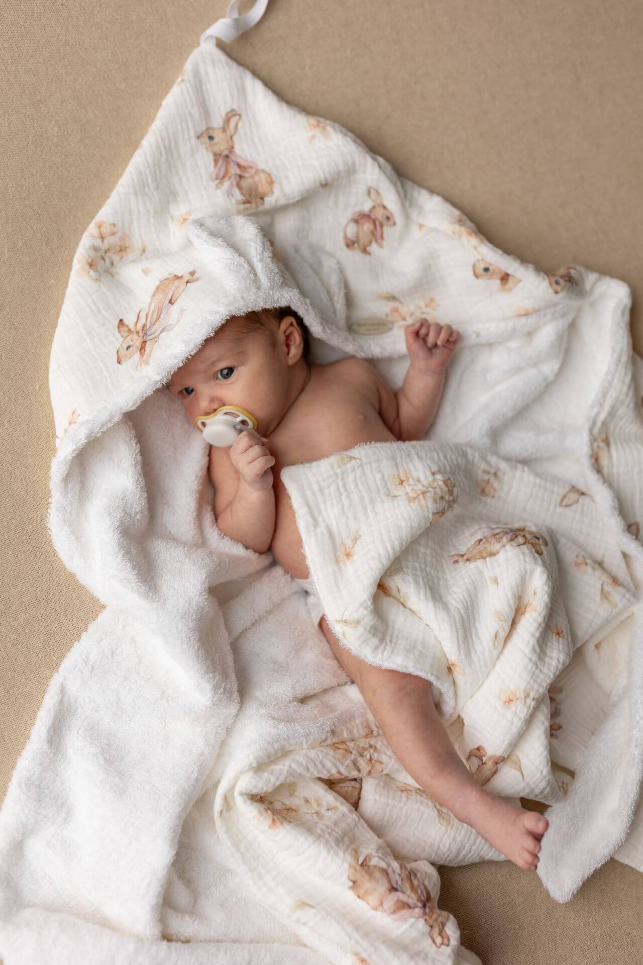 Wrap your baby in gentle comfort with our luxury bamboo baby towel. Made from bamboo terry and cotton muslin, it's hypoallergenic, and OEKO-TEX certified.