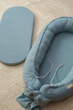 Discover our premium baby nest sleeper crafted with breathable linen and hypoallergenic fill. Provides a cozy, secure space for newborns.